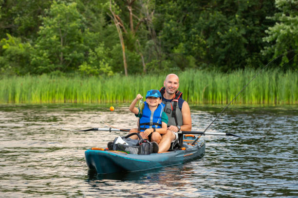istock Boy Holding Fish Just Caught While Kayak Fishing 2170674438