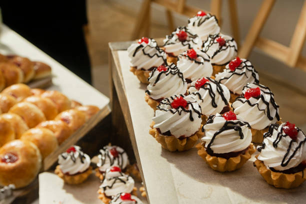 istock White cream cakes on a buffet table at a catering event. Food for a coffee break at a conference 2170679079