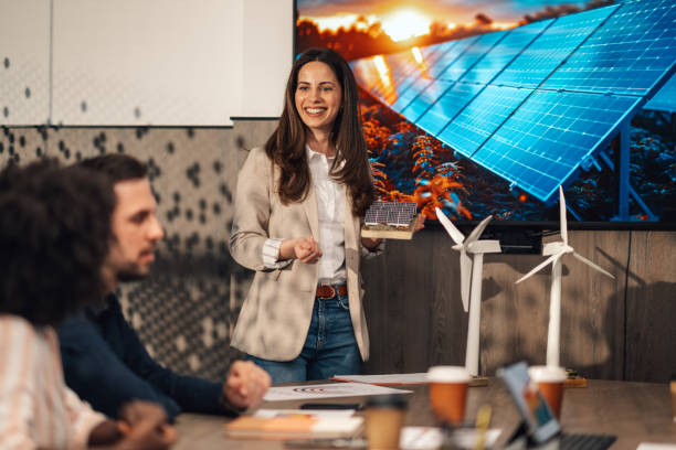 istock Businesswoman with solar panels model having presentation at office. 2170684332