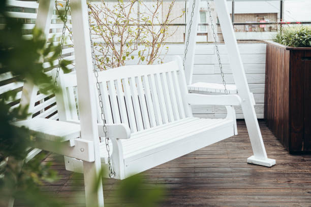 istock White wooden swing on the cafe terrace, bench for rest. 2170684729