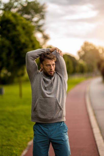 istock Athletic man stretching during outdoor exercise in the morning. 2170686281