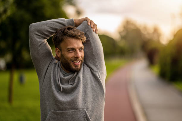 Athletic man stretching before outdoor exercise in the morning.