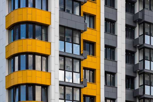 istock freshly built white-grey-yellow high rise apartment building, full-frame closeup 2170692303