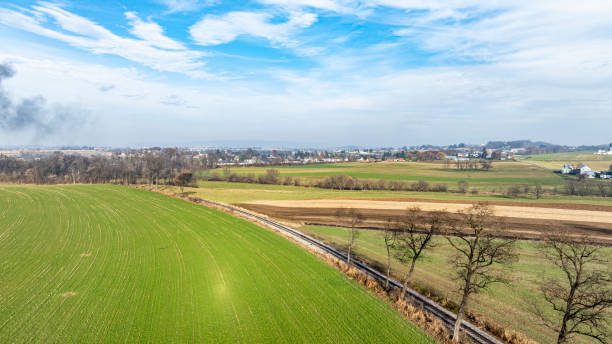 istock Vast Green Fields With Distant Towns and a Cloudy Blue Sky in Rural Landscape During Daytime 2170696144