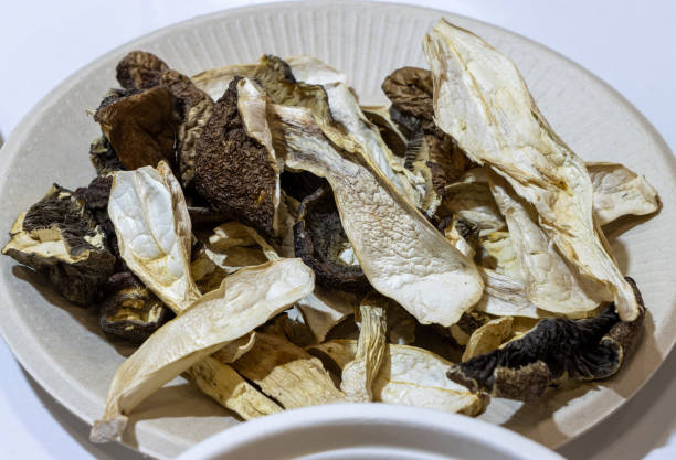 istock Red pine matsutake mushroom. Uncooked, In a white plate on an isolated background 2170696162