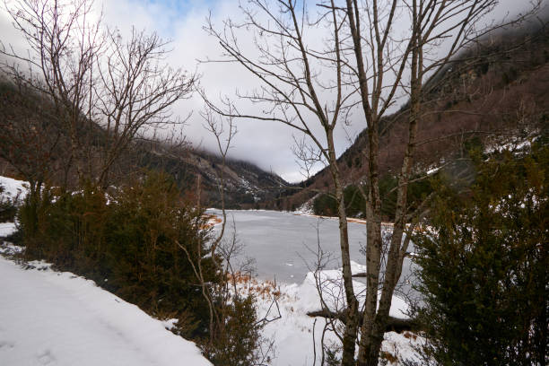 istock serene frozen lake nestled within a snowy valley 2170698765