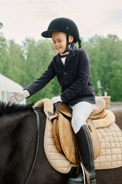 istock Smiling Boy Riding Horse in Outdoor Equestrian Setting 2170700477