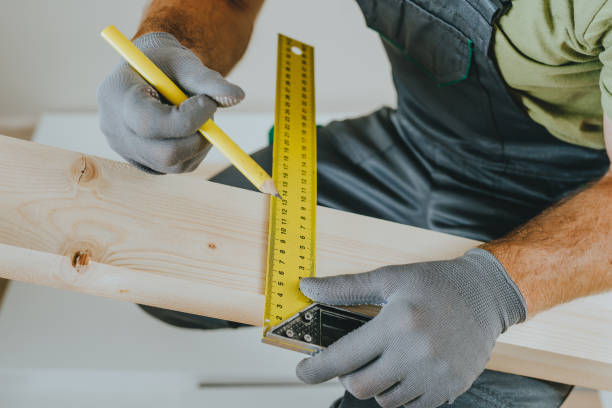 istock Close up of carpenter measuring wooden board using tools in his workshop 2170702987
