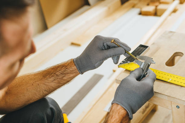 istock Close up of carpenter measuring a screw with a caliper in his workshop 2170703210