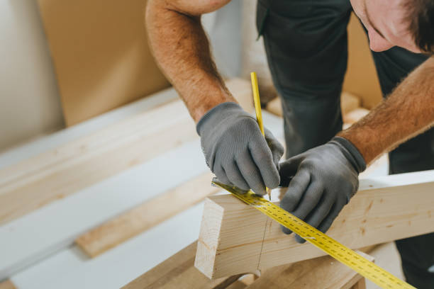 istock Close up of carpenter measuring wooden board using tools in his workshop 2170703220