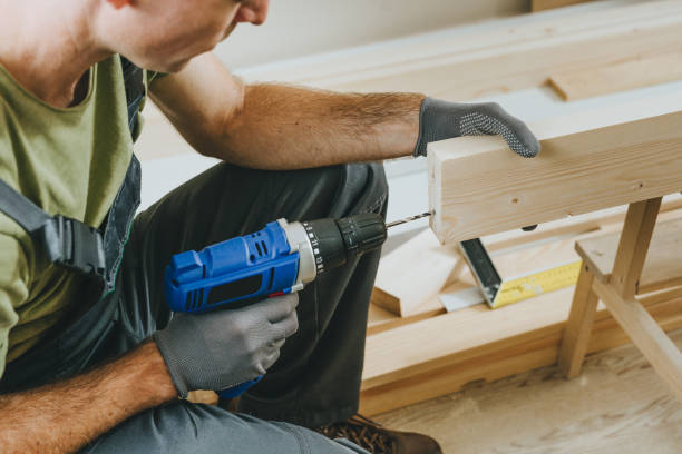 istock Close up of carpenter drilling a board with a screwdriver in his workshop 2170703884