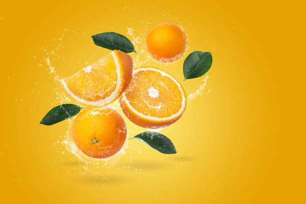 istock Water Splashing on Fresh Sliced Oranges and Orange Fruit on an Orange background 2170703984