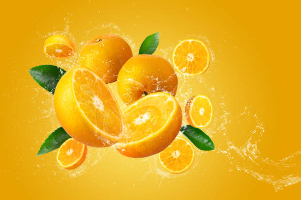 istock Water Splashing on Fresh Sliced Oranges and Orange Fruit on an Orange background 2170703992