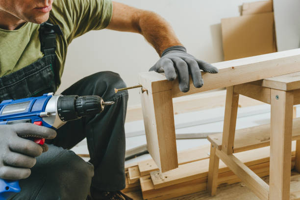 istock Close up of carpenter drilling a board with a screwdriver in his workshop 2170703995