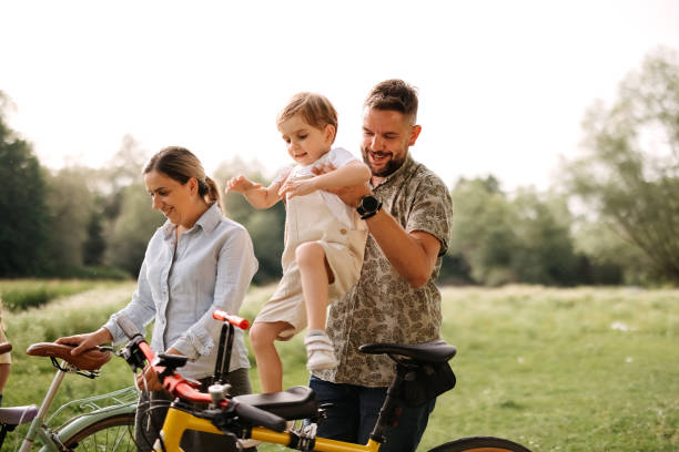 istock Family riding bicycles in the forest 2170704732
