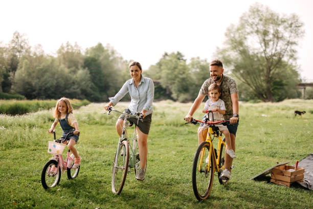 istock Family riding bicycles in the forest 2170704739