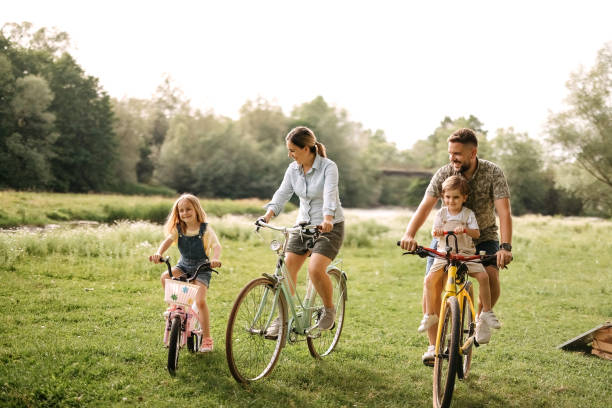 istock Family riding bicycles in the forest 2170704747