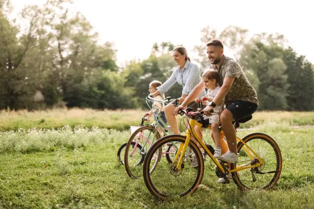 Family riding bicycles in the forest