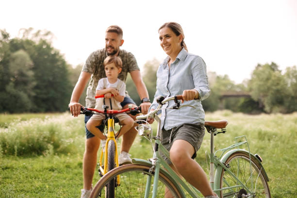 istock Family riding bicycles in the forest 2170704765