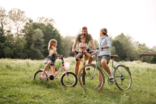 istock Family riding bicycles in the forest 2170704794
