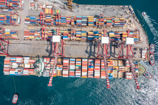 istock Aerial top view container ship in export and import business and logistics. Shipping cargo to harbor by crane 2170707113