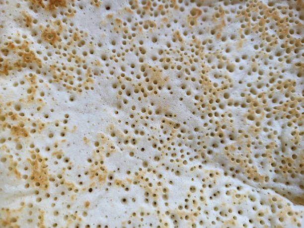 istock Light background of fried pancake with holes. 2170712198