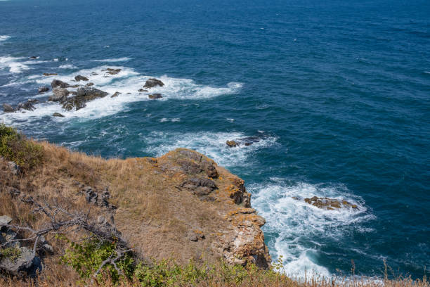 Waves crashing into rocks in the ocean.