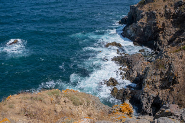 Waves crashing into rocks in the ocean.