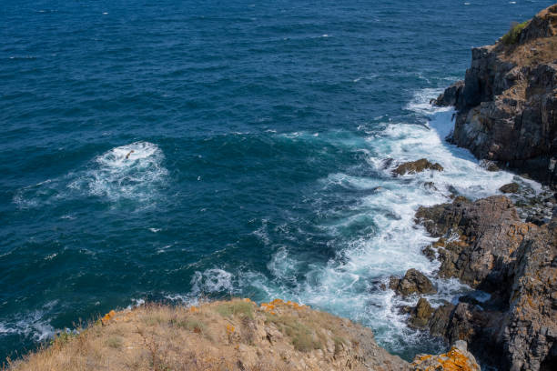 Waves crashing into rocks in the ocean.