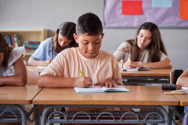 istock Group of preteens concentrated studying in the classroom. 2170715508