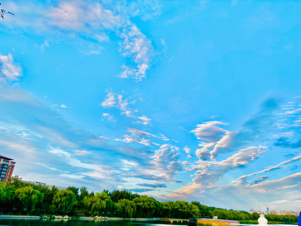 Sunset, Sky clouds over sea in the Evening with Orange, Yellow Gold sunlight in Golden hour and Dramatic fluffy, Horizon sea Summer sky landscape, Dusk sky background