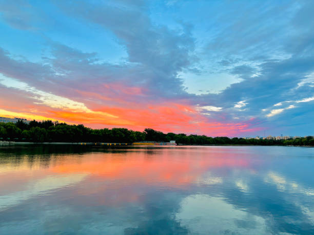 Dusk, Sunset Sky Clouds in the Evening with colorful Orange, Yellow, Pink and red sunlight and Dramatic storm clouds on Twilight sky, Landscape horizon Golden sky nature Summer Background from beijing