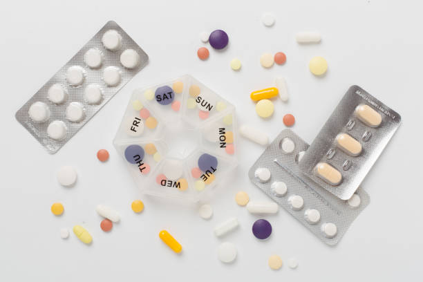 istock Daily pill organizer with medications on color background, top view 2170723994