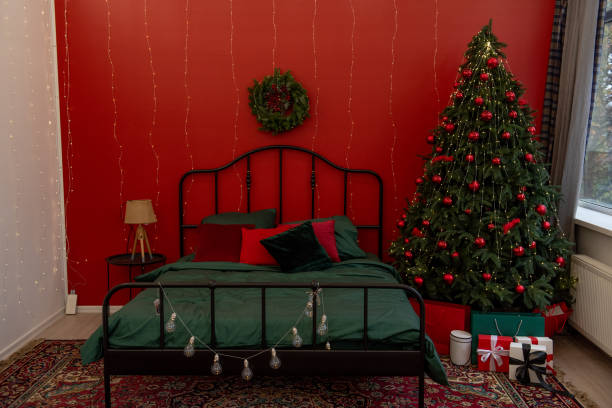 istock Cozy Bedroom Interior Decorated for Christmas with Tree and Lights 2170725301