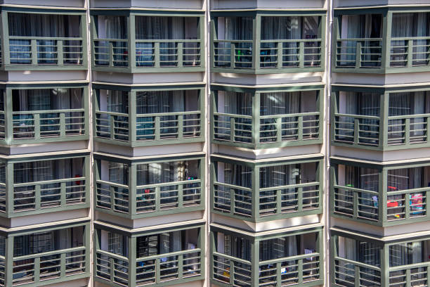 Contemporary multi-story hotel in Antalya, Turkey, featuring a white facade and staggered balconies that create a geometric visual rhythm. Surrounded by palm trees and bathed in clear daylight, the building blends Mediterranean climate with modern design. Ideal for visuals focused on coastal hospitality, architectural elegance, and upscale travel accommodations.