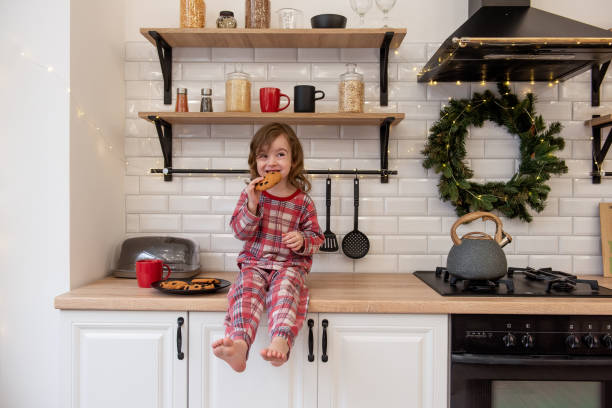 istock Child Enjoying Cookie in Festive Kitchen 2170729705