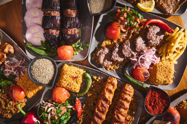 istock Assorted Turkish cuisine with grilled meats, bulgur, and fresh vegetables served on stylish plates, showcasing a vibrant mix of traditional flavors and culinary artistry in a beautiful presentation. 2170732498