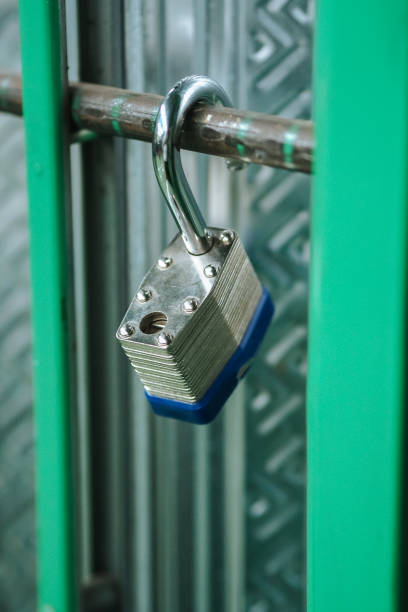 istock The padlock hung open, on the green door 2170733665