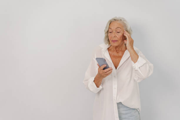 istock A Senior Woman is Using a Smartphone and Exhibiting a Concernful Expression on Her Face 2170735677