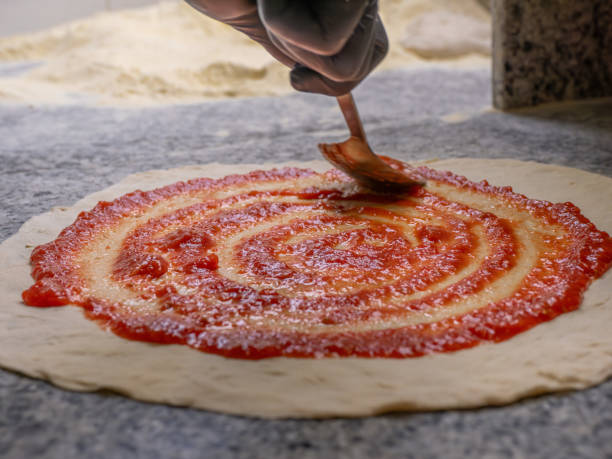 istock Put the tomato sauce on the pizza dough 2170736391