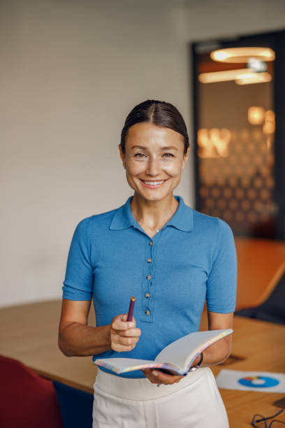 istock A Smiling Professional Woman Working in a Bright and Modern Workspace Environment Setup 2170740596