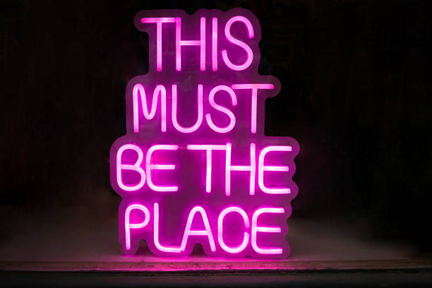 istock Text, message written in pink neon on black background. Uppercase letters 2170745058