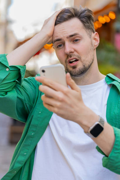 istock Sad man using smartphone browsing loses lottery casino application results bad news fail virus 2170747550