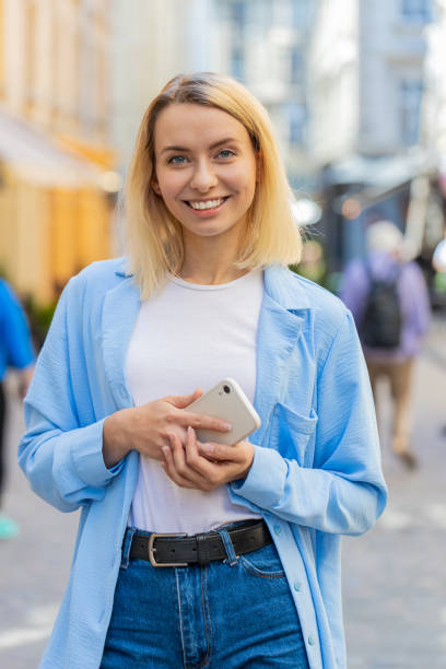 istock Woman use mobile smartphone typing text messages browsing internet finishing work looking at camera 2170747582