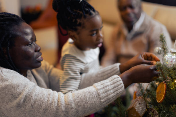 istock Family Decorating Christmas Tree Together 2170749258