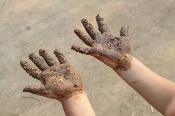 istock Mud covered hands of a child.  Children playing in mud 2170749274