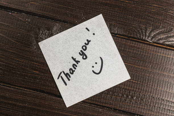 istock White thank you note on wooden table 2170752767