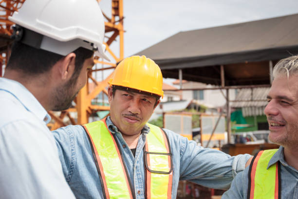istock Team of workers at construction site with heavy machines. 2170761273
