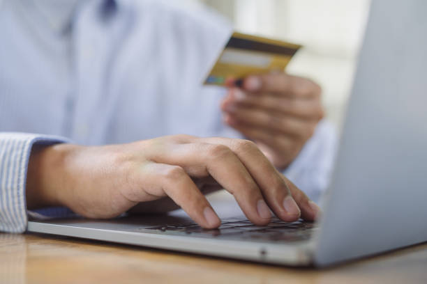 istock Young man making payment success using credit card while shopping on online retail shop with laptop computer on table at coffee cafe, lifestyles technology 2170765059