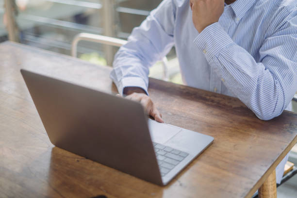 istock Business man on laptop computer keyboard on office table, online working, surfing the internet, distant job, remote work concept 2170767300